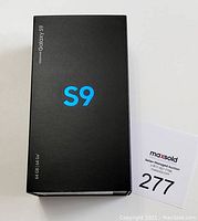 Sealed black Galaxy S9 box with "S9" logo and "64 GB" storage marking