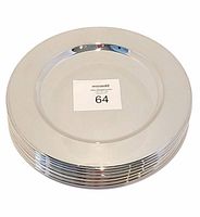 Stack of shiny silver plated round chargers with smooth reflective surface and raised rim, showing thickness and shine