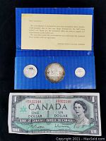 Blue folder containing three Canadian silver coins and a letter from Brooke Bond Canada Limited explaining the scarcity of the 1967 silver dollar.
