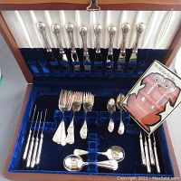 Full view of entire canteen set showing knives, forks, spoons arranged in velvet-lined wooden case with white satin lid lining