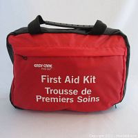 Closed red Easy Care first aid kit bag with black trim and handle, front showing branding text in English and French.