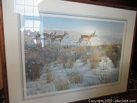 Full view of framed limited edition print depicting pronghorn antelopes in a winter grassland scene.