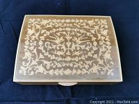 Closed rectangular wooden jewelry box with detailed floral and bird inlaid design on the lid, natural wood finish.