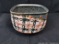 Square-shaped ceramic bowl with hand-painted pink and black floral designs on the exterior and a dark gray glazed interior.