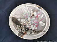 Top view showing the overall glaze pattern with abstract and multi-colored design on the dish surface.