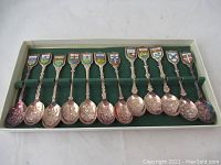 Full view of set of 10 provincial commemorative collector spoons in box