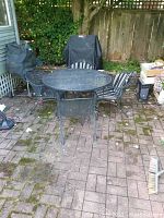 Full set of round table and four chairs on brick patio