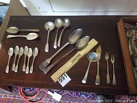 Overhead view of full flatware assortment on table