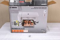 Original retail box of Canon Pixma MG3520 printer showing picture of printer and sample photo prints
