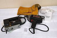 Black & Decker jigsaw, Sears Mastercraft drill, brown toolbelt, and PIR motion sensor in box
