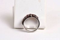 Side view of natural garnet sterling silver ring showing the gemstone arrangement and band.