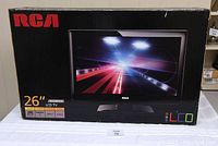 Front view of the boxed RCA 26-inch LCD TV showing brand, size and specifications.