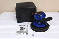 Simoniz 10" electric car polisher with foam pad, carrying case, and manual on a white cloth background