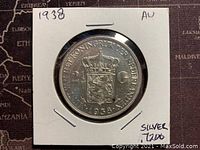 Front of 1938 Netherlands silver 2½ gulden coin showing crown and coat of arms.