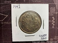Reverse side of the 1942 Canadian 50 cent silver coin showing the Canadian coat of arms