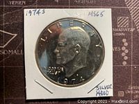 Front side of 1974S Eisenhower Silver Dollar coin showing Eisenhower's profile with date and inscriptions, in protective holder.
