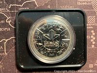 Reverse of the coin showing the Commonwealth Games emblem and inscriptions.