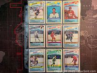 Front view showing 9 different player cards in plastic sleeve from the 1984-85 O-Pee-Chee NHL Goal Leaders series.