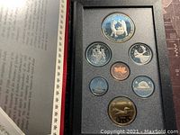 Photo of the front view of the coin set inside the presentation case showing all coins including the large double dollar coin and smaller denominations.