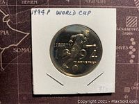 Obverse side of the 1994P US World Cup Dollar coin showing the soccer player, year, and 'LIBERTY'.