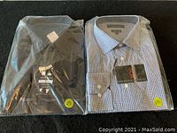 Two men's dress shirts in plastic packaging, one black and one blue/white checkered, size tags visible