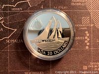 Obverse side of silver coin showing The Bluenose sailing ship and denomination.