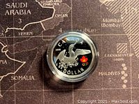 Obverse side of the coin showing the Loon bird with wings spread and a colored Canadian maple leaf Olympic logo, inscribed with 'CANADA', '2008', and 'DOLLAR'.