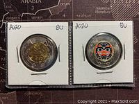 Two 2020 Canadian dollar coins in 2x2 holders; one showing the coloured Bill Reid indigenous design on the reverse side, labelled '2020 BU'.