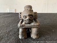 Front view showing the figurine's face, posture, and details of the arms and legs.