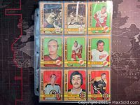 Photo of assorted 35 hockey trading cards from 1972-73 O-Pee-Chee NHL series in plastic sleeves showing front artwork and player photos