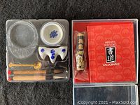 Full view of contents in fitted plastic tray, including brushes, ink stone, brush rest, dish, water dropper, and ink stick alongside box