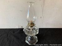 Full view of the vintage glass table oil lamp showing the hexagonal clear glass base and chimney