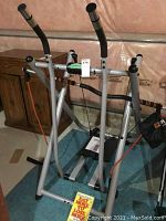 Front view of Tony Little Gazelle Platinum glider fitness machine, showing frame and handles