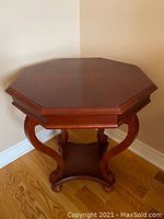 Top front angle showing octagonal shape and details of the table's top and legs.