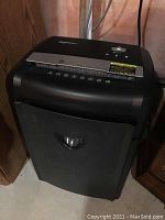 Front view of black Amazon Basics paper shredder showing full unit and collection bin.