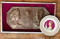 Full view of the framed copper plaque and the commemorative plate placed on wooden surface