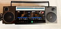 Full front view of vintage Prosonic boombox showing dual cassette compartments, speakers, control buttons, and carrying handle.