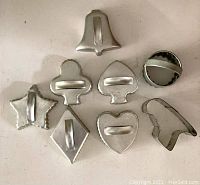 Top view showing all 8 metal cookie cutters arranged in two rows on a flat surface.