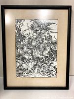 Framed black and white print showing Four Horsemen of the Apocalypse in a vertical rectangular frame with beige matting, photographed against a neutral wall.