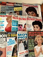 Photo of 11 vintage Hollywood movie magazines from 1951-1969 showing covers with classic movie stars and celebrity news headlines.