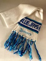White knit scarf with blue and teal stripes and fringes, displaying 'BLUE JAYS' text and sewn 'Bittner's' label.