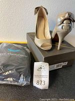 Full view of pumps on box alongside packaged neck hammock