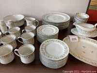 Full set overview showing all plates, cups, saucers, serving pieces arranged on table