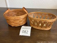 Both baskets placed on table with auction lot number card