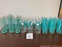 Photo shows all 19 glasses arranged in three groups according to type on table.