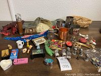 Full lot on tabletop showing flashlight, mugs, masks, figurines, and assorted small items