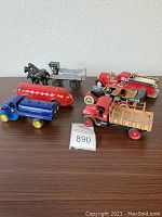 Full lot view showing six vintage Texaco and related branded die cast vehicles on a wooden surface, highlighting scale and group composition