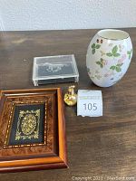 The full lot, showing all four main items on a flat surface: the Wedgwood vase, framed artwork, acrylic box with horse design, and vial of gold flakes.