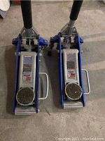Pair of blue and silver Pittsburgh Racing 1.5 Ton floor jacks with RapidPump feature, side by side on concrete floor.