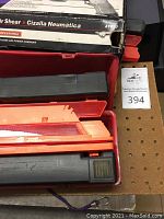 DeVilbiss Air Shear tool in black and orange case with box showing product branding and features